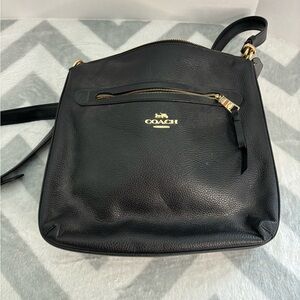 Coach crossbody purse in black with gold metal accents.